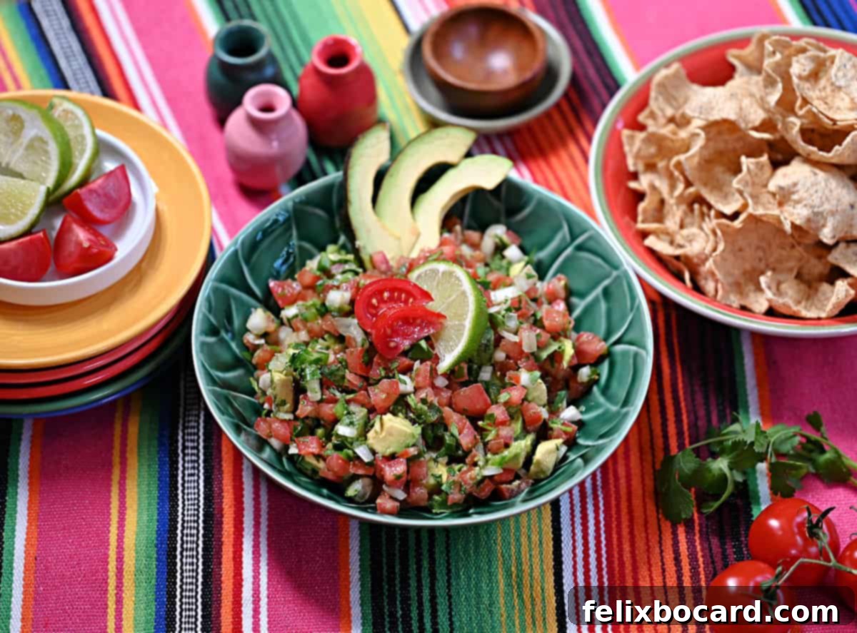 Avocado Pico de Gallo 9 A large bowl of Pico de Gallo with Avocado, perfectly garnished and served with a variety of colorful tortilla chips.