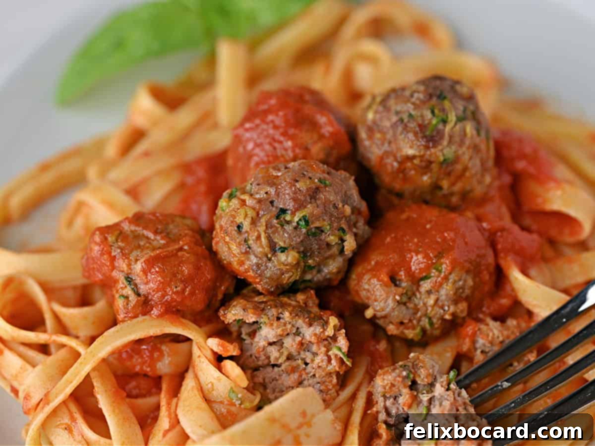 Garden Fresh Beef & Zucchini Meatballs 2 Zucchini meatballs in a rich red sauce, served over a bed of fettuccine noodles, garnished with fresh herbs.