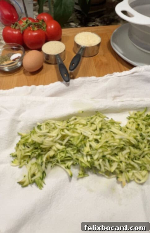Garden Fresh Beef & Zucchini Meatballs 5 Shredded zucchini spread out on a white kitchen towel, ready for squeezing.