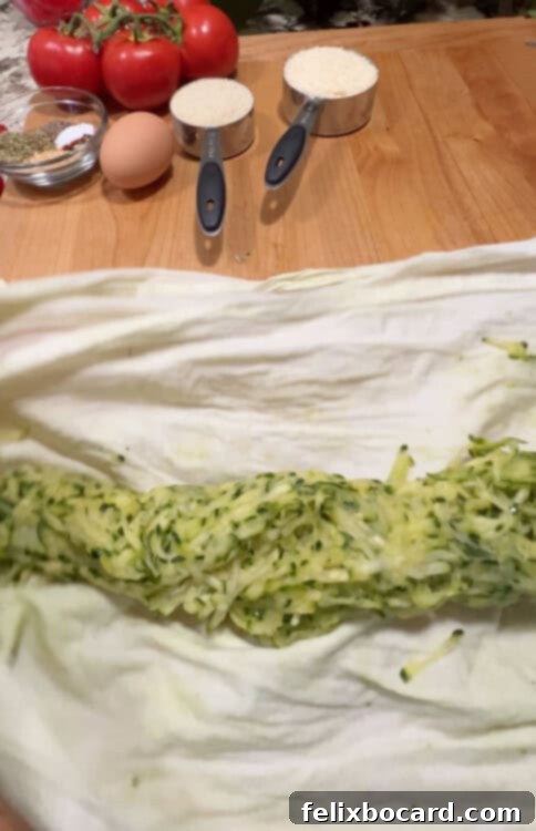 Garden Fresh Beef & Zucchini Meatballs 7 A close-up of a small mound of thoroughly squeezed shredded zucchini, appearing dry and ready for use.