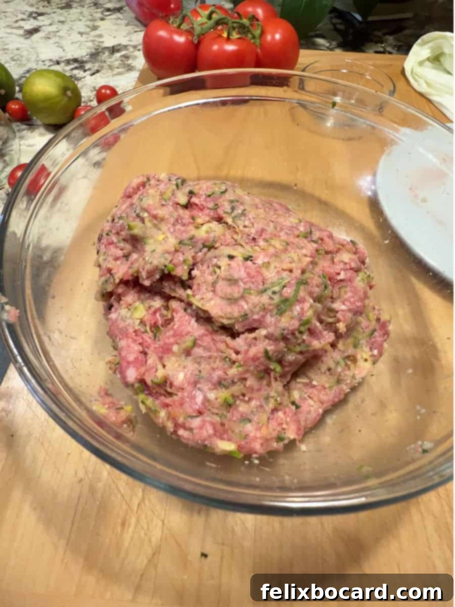 Garden Fresh Beef & Zucchini Meatballs 8 A mixing bowl filled with the ground beef meatball mixture, including shredded zucchini, ready to be formed into balls.