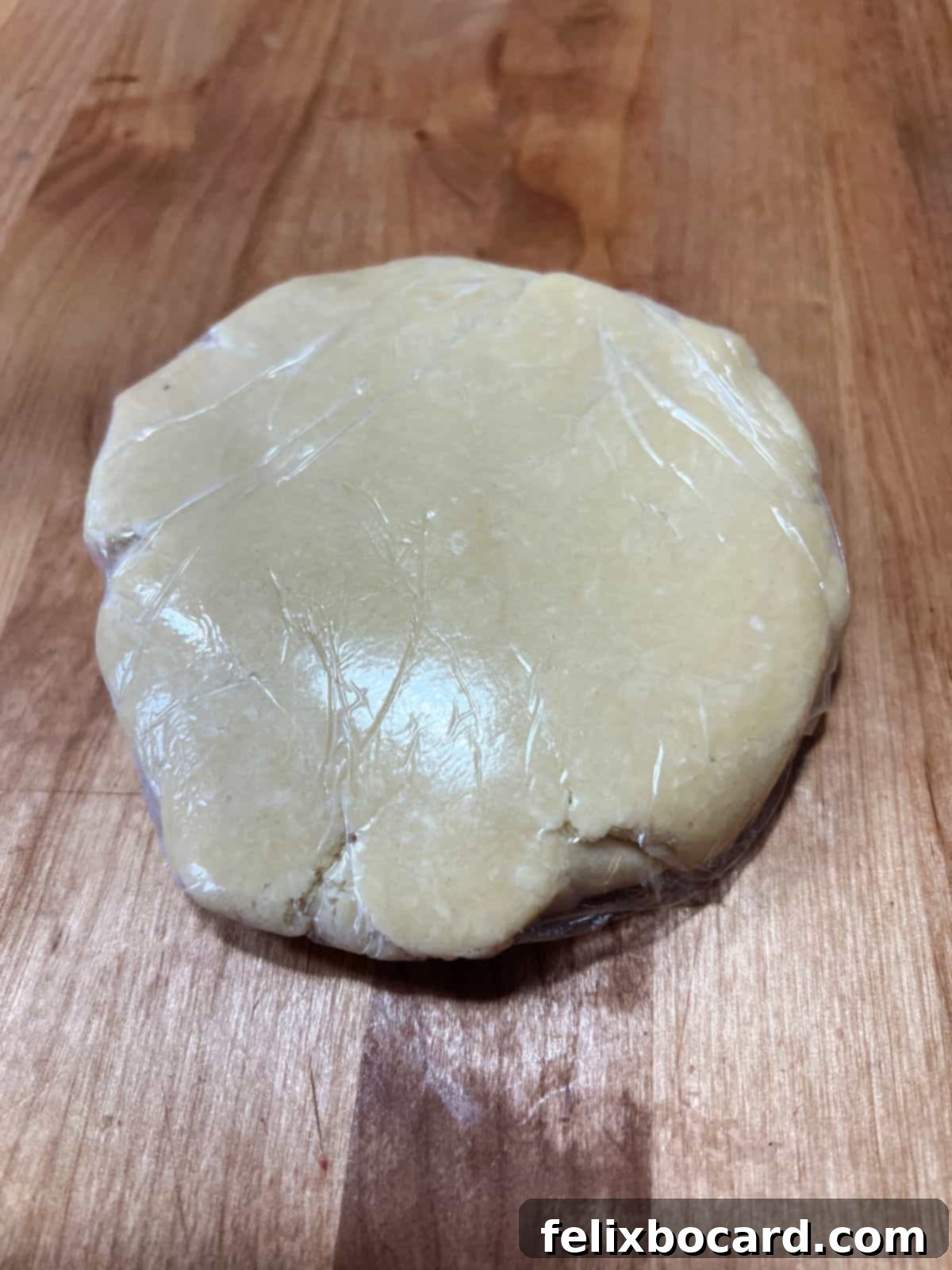 pie crust dough in platic wrap.