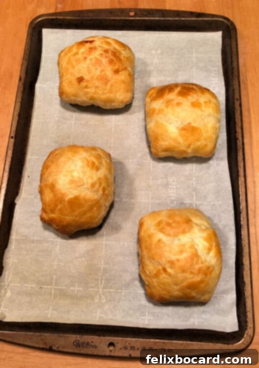 4 baked puff pastry hand pies on the baking sheet