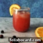 A chilled glass of Cranberry Spritzer, garnished and ready to serve