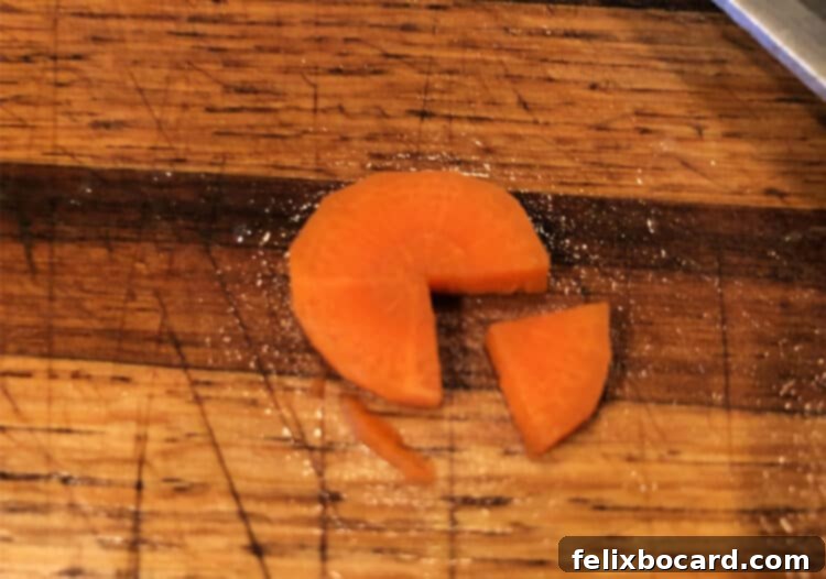 Penguin Party Bites 4 Close-up image demonstrating how to cut carrot slices into penguin feet and a small wedge for the beak.