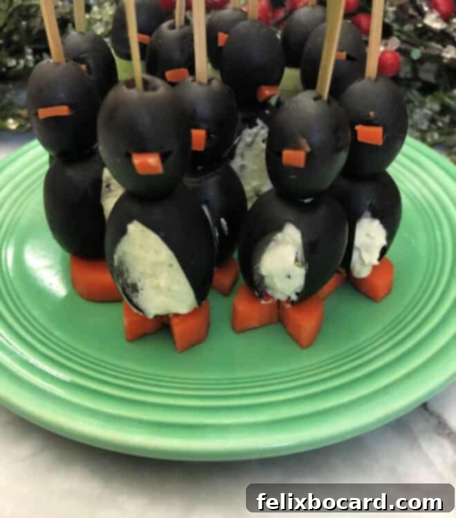 Penguin Party Bites 7 Group of finished cream cheese penguin appetizers standing upright, showcasing their festive and cute appearance, ready for serving.