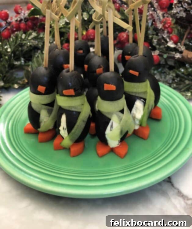 Penguin Party Bites 8 Cream cheese penguin appetizer adorned with a delicate cucumber scarf, adding an extra festive and charming touch.