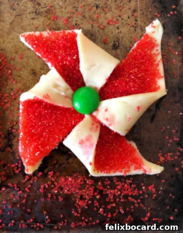 unbaked poinsettia cookie with a green M&M center