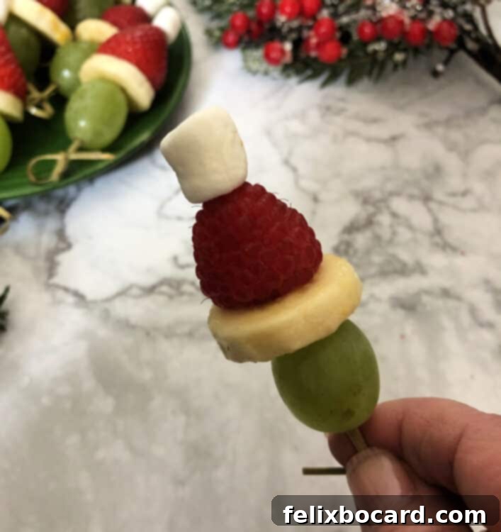 Grinch Fruit Skewers 4 Platter of vibrant Grinch appetizers ready for a holiday gathering.