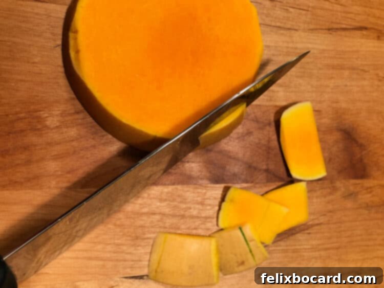 Golden Butternut Squash Chowder 4 A knife carefully removing the skin from a squash slice.