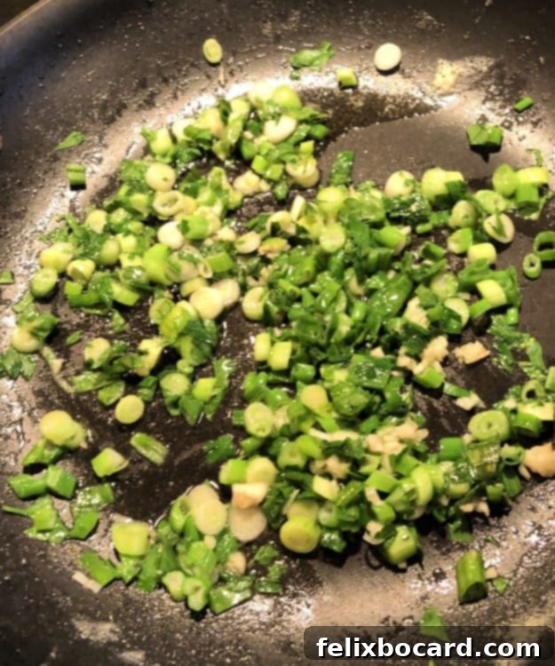 chopped onions and parsley cooking in skillet