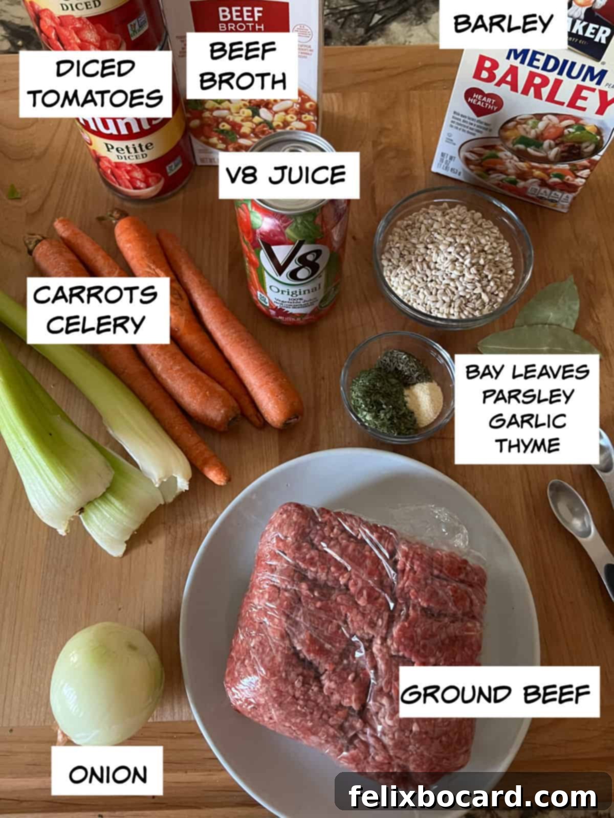 Ground Beef Barley Soup 4 A flat lay photograph showcasing all the fresh ingredients for Hamburger Barley Soup: diced tomatoes, beef broth, V8 juice, crisp carrots, fresh celery, a whole onion, lean ground beef, pearled barley, and a selection of aromatic spices.