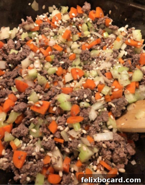 Ground Beef Barley Soup 5 Ground beef, chopped onions, carrots, and celery cooking together in a large pot for the soup base.