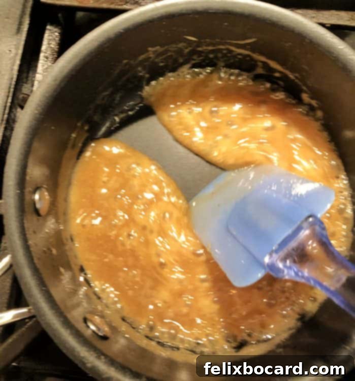 Caramel mixture almost ready, thickening and darkening in the pan.