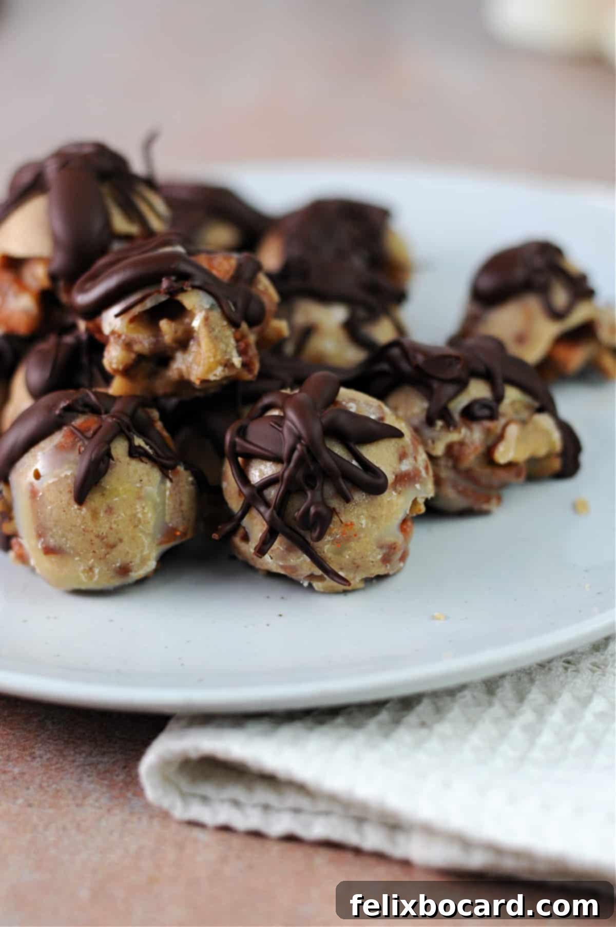 A stunning plate of chocolate-drizzled keto pecan clusters, ready to be enjoyed.