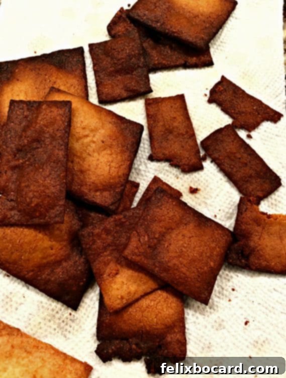 A tray of overcooked keto crackers, dark brown and visibly brittle, highlighting the importance of proper baking time.