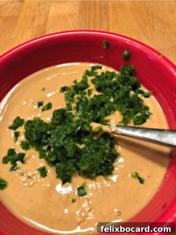 Cashew crema sauce in a red bowl, a key component for delicious vegan cauliflower tacos