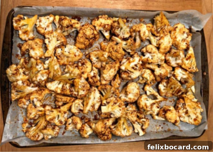 Roasted and spiced cauliflower on a baking sheet, ready for assembly into delicious tacos