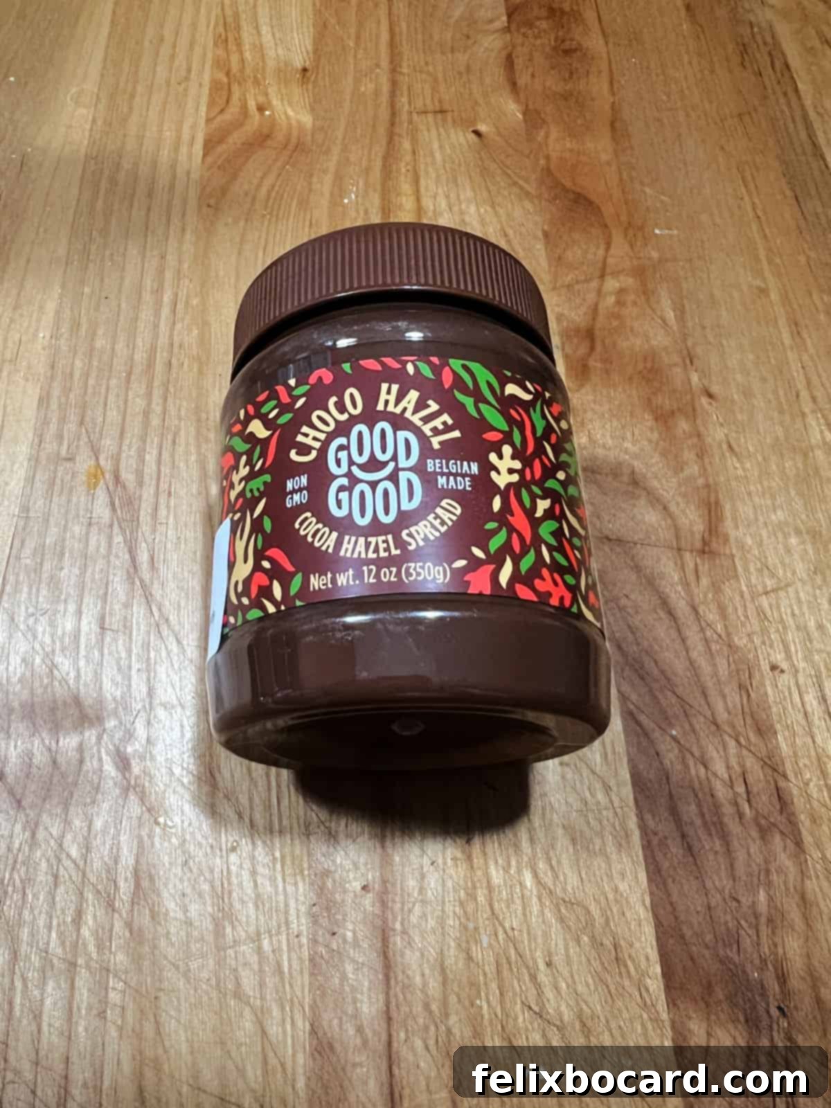 Jar of sugar-free chocolate hazelnut spread, a key ingredient for keto-friendly desserts.