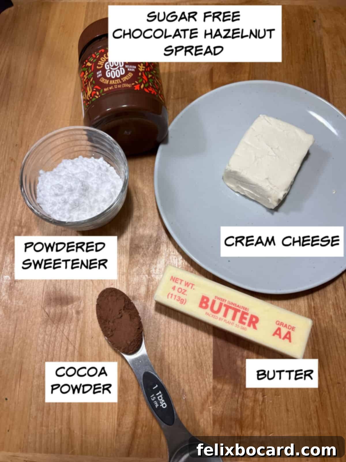 A collection of ingredients for keto Nutella fat bombs, including sugar-free chocolate hazelnut spread, cream cheese, butter, cocoa powder, and powdered sweetener.
