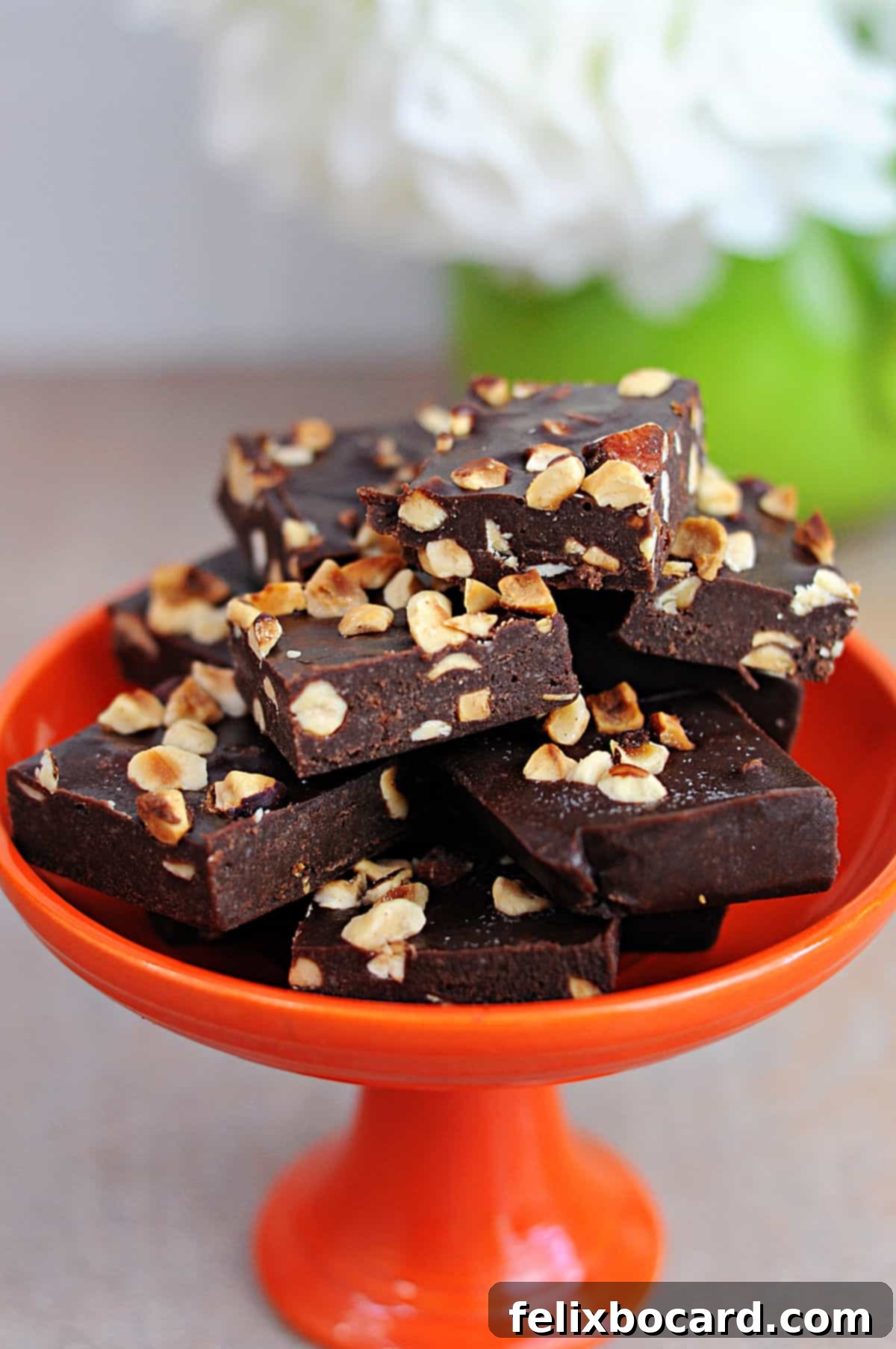 A small candy dish piled high with perfectly cut keto Nutella snack squares, ready to be enjoyed as a low-carb treat.