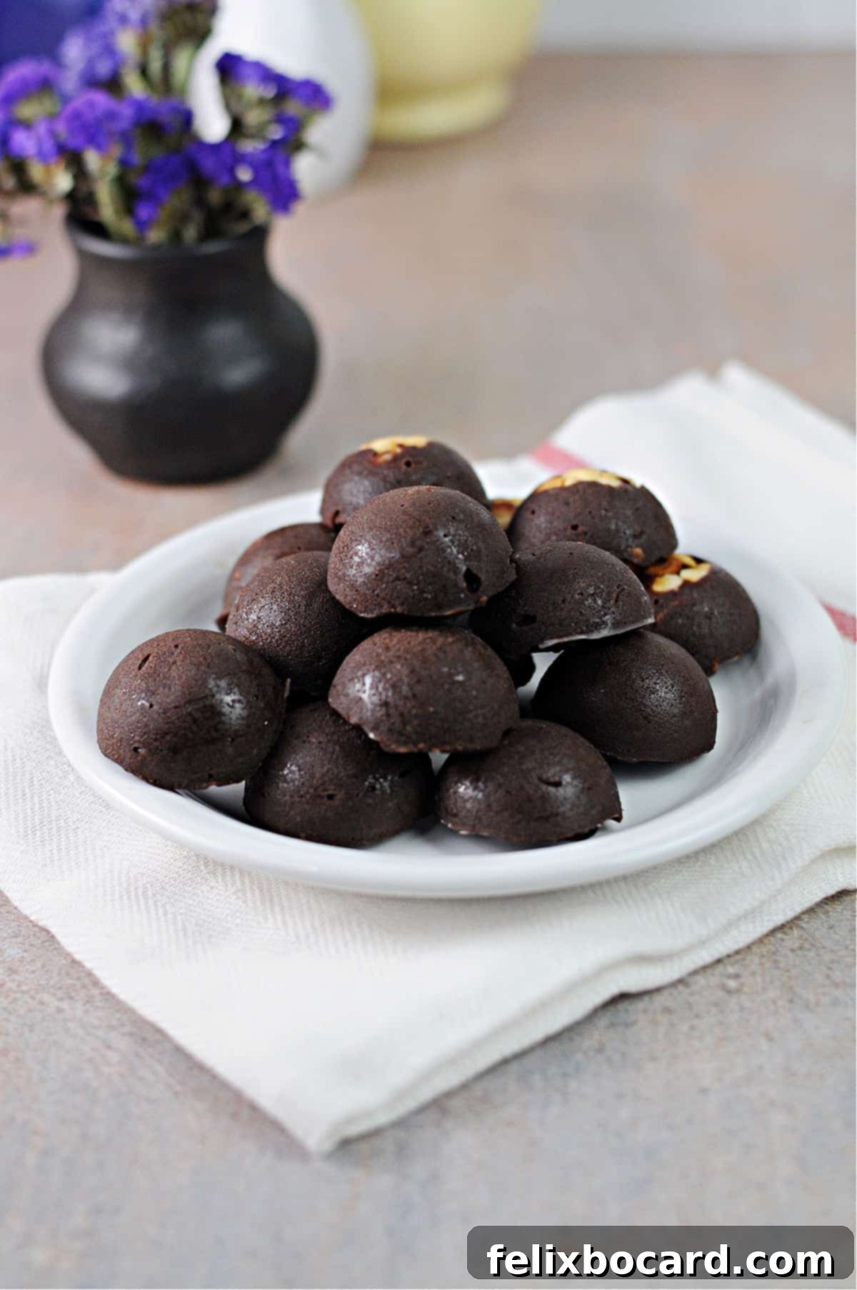 A plate featuring perfectly molded keto Nutella snacks in a smooth half-sphere shape, highlighting their enticing texture.