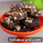 A close-up of a keto Nutella fat bomb, showcasing its fudgy texture and rich chocolate-hazelnut flavor, cut into a square shape.