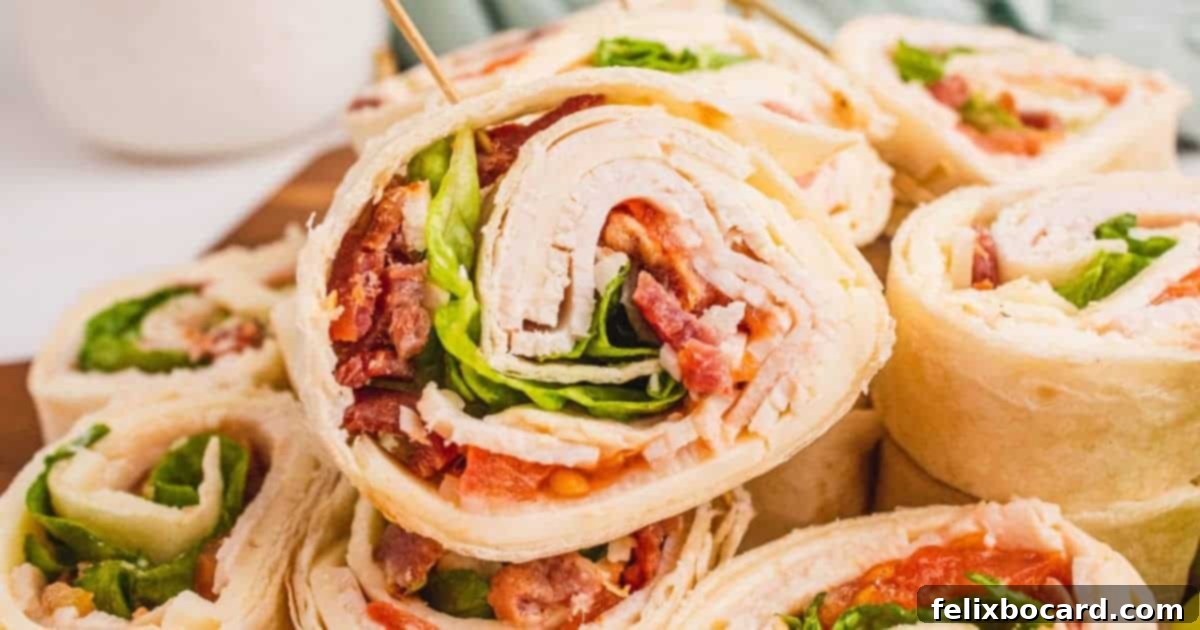 Club Sandwich Pinwheels, a creative appetizer featuring deli turkey, crisp bacon, provolone, lettuce, and tomato rolled in tortillas.