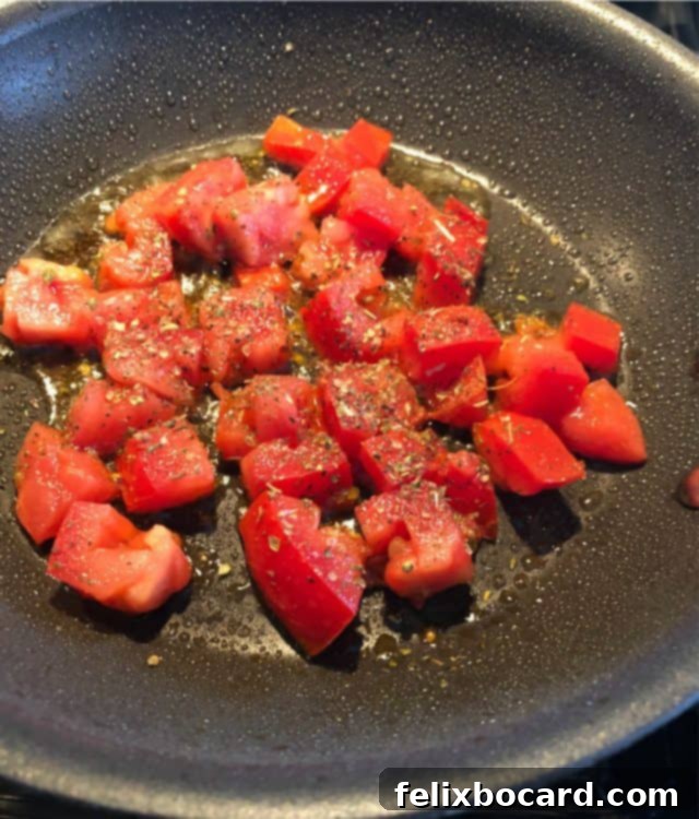 Supercharged Eggs 2 diced tomato in a skillet