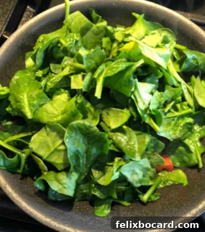 Supercharged Eggs 3 fresh spinach added to skillet