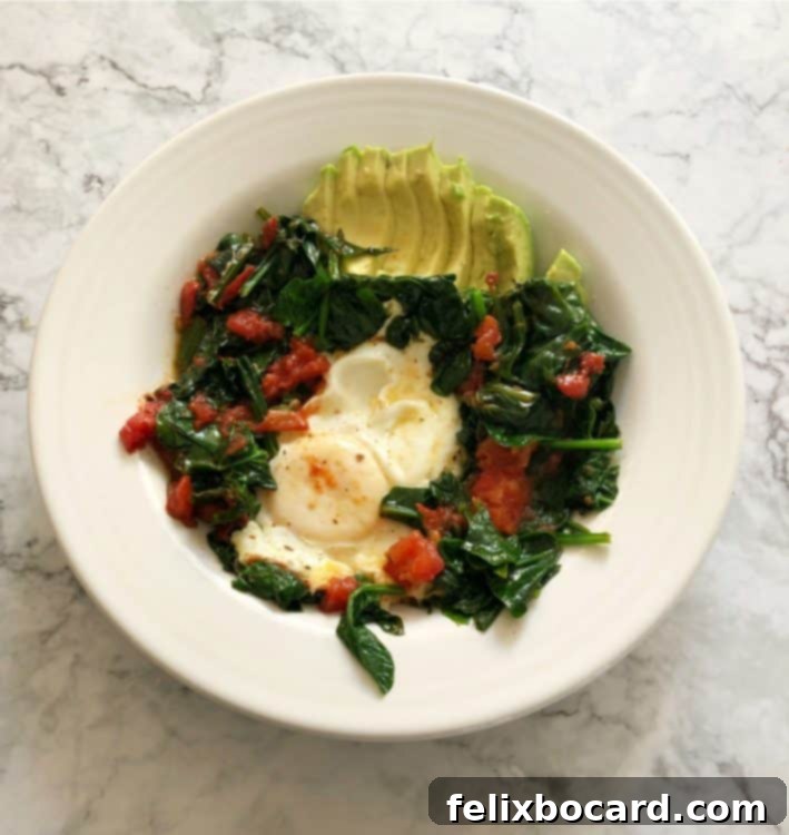 Supercharged Eggs 8 eggs and veggies in a white bowl with avocado