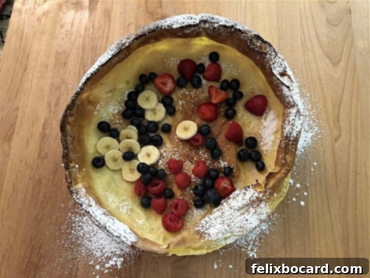 Dutch Baby pancake with fresh berries and sliced banana