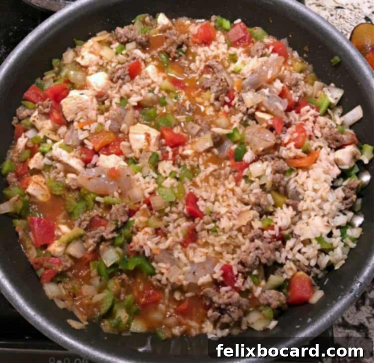 Weeknight Jambalaya 5 Jambalaya mixture simmering in a large skillet, covered.