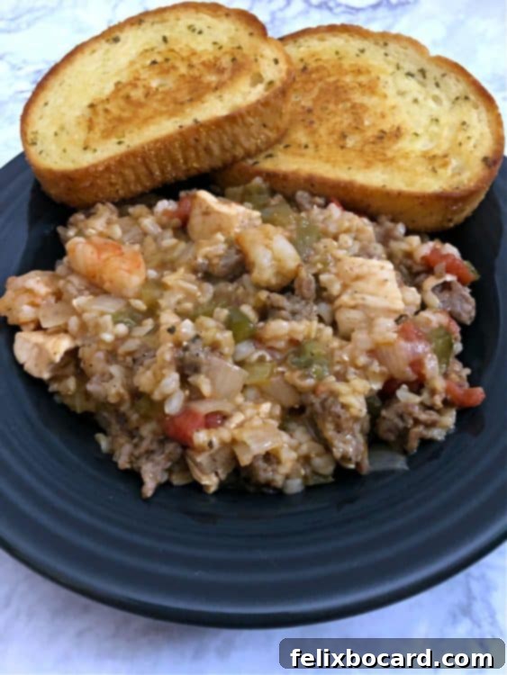 Weeknight Jambalaya 7 Jambalaya in a bowl served with a side of garlic bread.