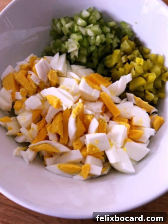 chopped hard boiled egg, celery and pickle in a bowl