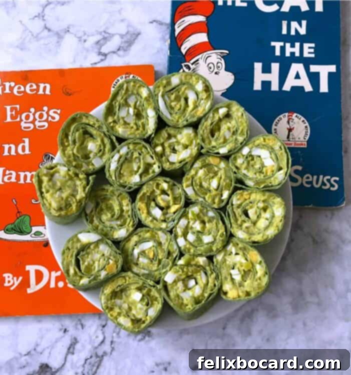 Egg salad pinwheels on a white plate with Dr Seuss books behind