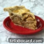 slice of apple pie on a red plate