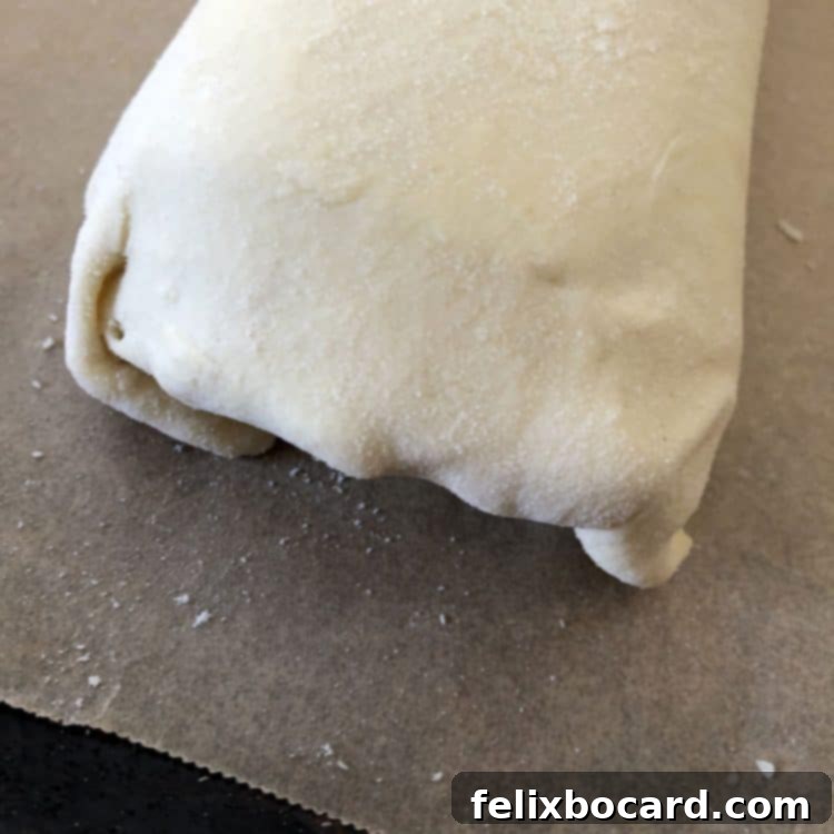 Tucked and sealed end of a rolled puff pastry Stromboli