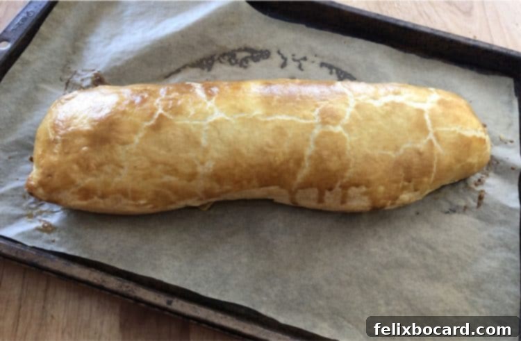 Freshly baked puff pastry Stromboli on a baking sheet
