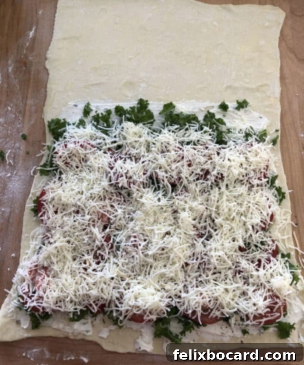 Adding a layer of cheese to the vegetarian Stromboli fillings