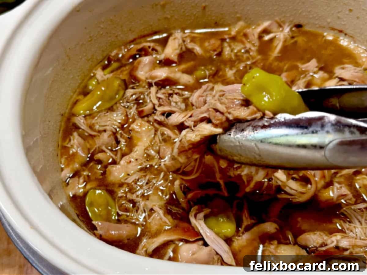 Shredded chicken in the crock pot ready to serve.