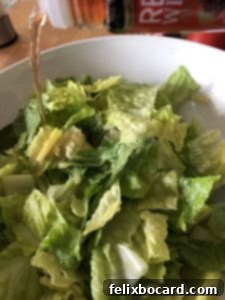 adding vinegar to salad in a bowl