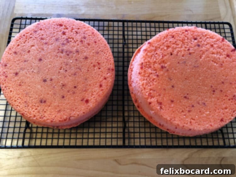 Jam-Filled Doughnut Bake 4 Two freshly baked strawberry cake layers cooling on a wire rack