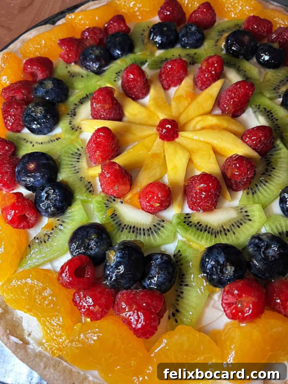 Close up of fully decorated fruit pizza.