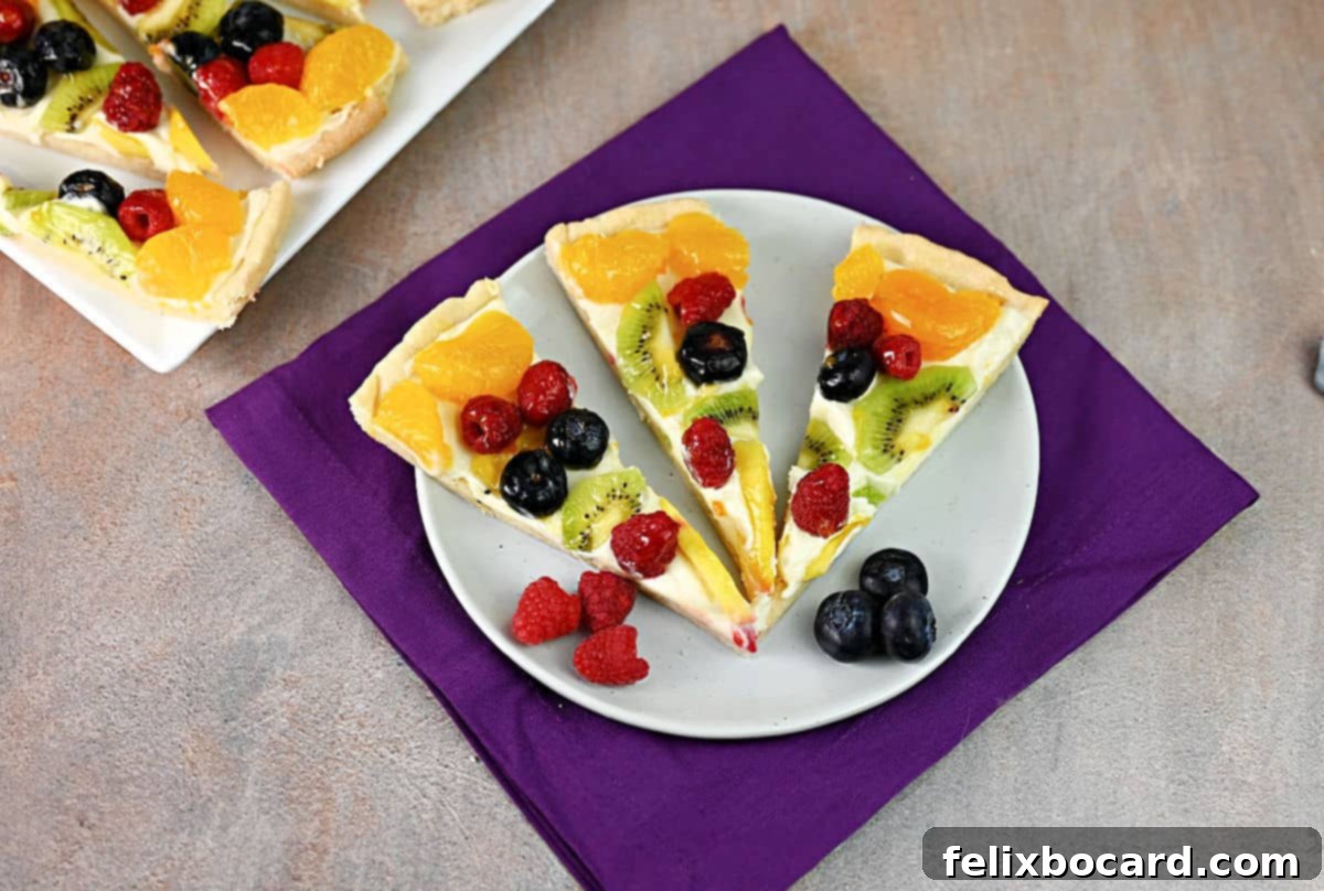 3 slices of fruit pizza on a small plate, ready to eat!