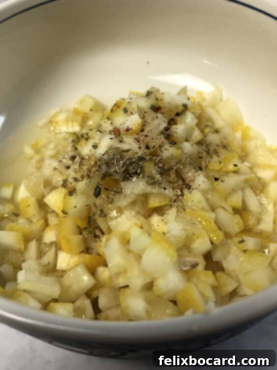Close-up shot of the vibrant whole lemon dressing, featuring finely chopped lemon pieces, garlic, and herbs, in a small mixing bowl.