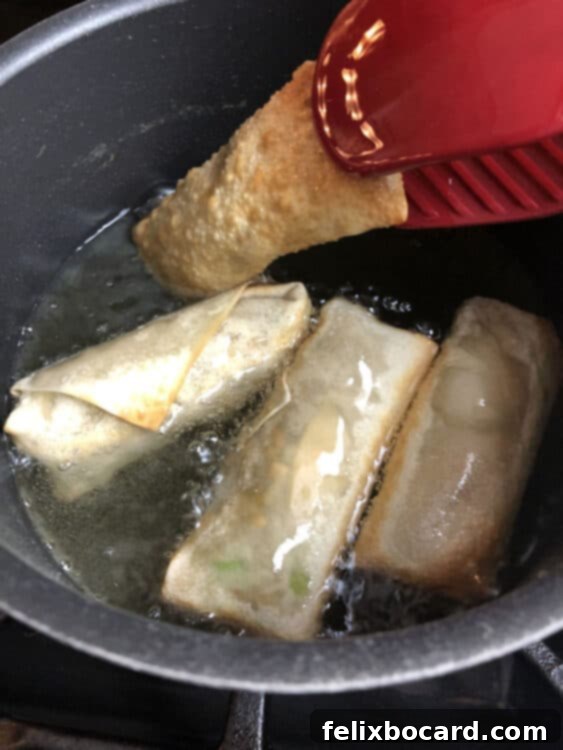 turinign egg rolls in the oil