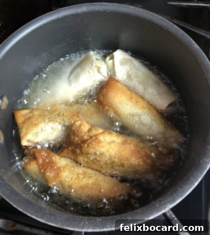 egg rolls cooking in oil
