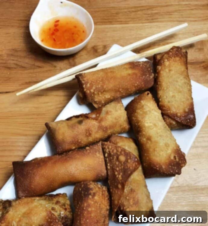 arrangement of homemade eggg rolls on a platter with dipping sauce