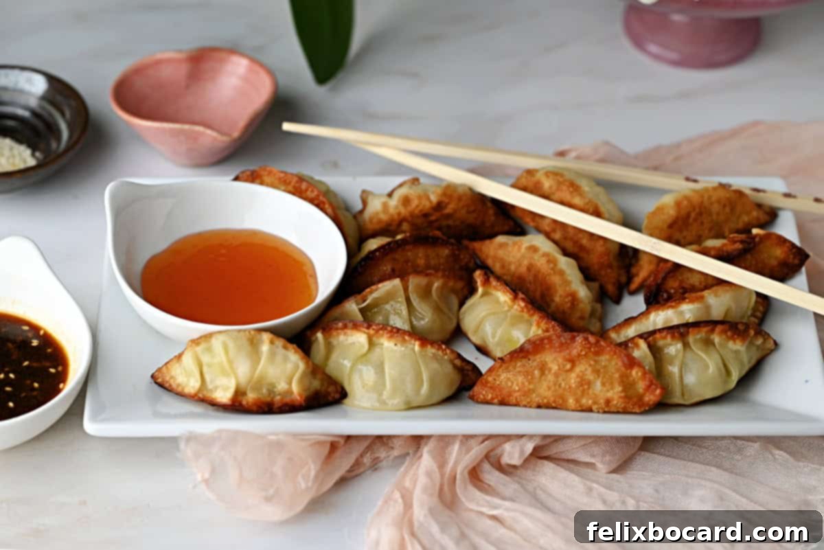 Golden-brown potstickers (Chinese dumplings) served with a small bowl of savory dipping sauce, ready to be enjoyed.